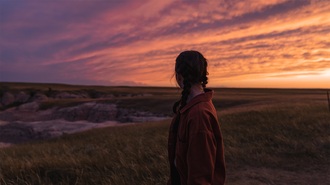 person looking at sunset